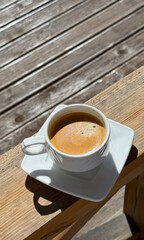 Sun-kissed espresso in white porcelain whispers Tuscan mornings, energizing siesta escape, International Coffee Day indulgence, artisanal warmth