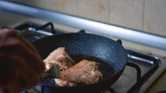 Close-up of pork frying in a pan for traditional Peruvian dish Pan con Chicharron. Street food preparation, authentic Latin American cuisine, sizzling meat cooking concept.