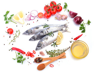 Fresh fish mackerel with spices and vegetables on a white background