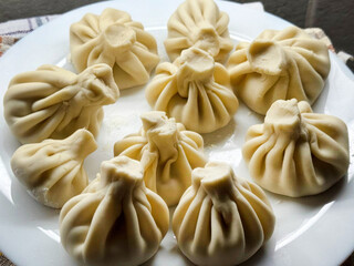Softly pleated dumplings dance on a plate, evoking flavors of Georgian Supra feasts and the lunar Festivities of Teej