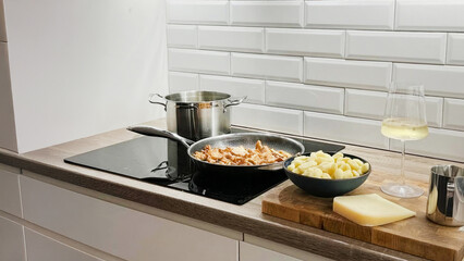 Golden-hued risotto simmers alongside bubbling fondue, echoing whispers of Alpine Traditions Day and Umami Appreciation Week in a sleek kitchen