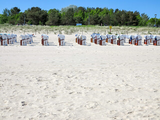Vast Sandy Beach Landscape with a Distant Row of Beach Chairs