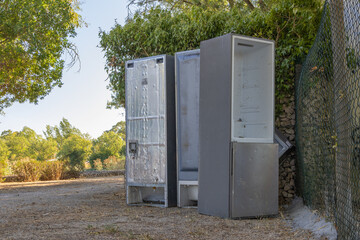 Abandoned old refrigerators polluting natural outdoor environment