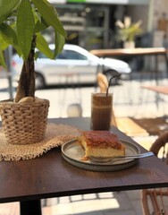 Syrupy pastry basking in sunlight beside iced coffee, urban cafe vibes, cozy brunch, World Scone Week, slow-living essence