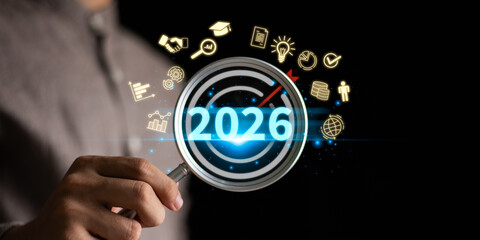 Concept of business goals and strategic planning 2026 with magnifying glass focusing on target, innovation, success, growth, and future achievement in finance, education, global business strategy.