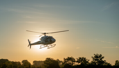 Helicopter flying at sunset