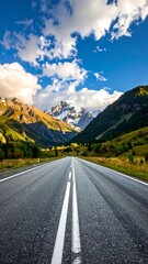 Naklejka premium Asphalt road vanishing into a mountain valley under a vibrant sky