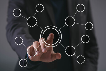 Businessman hand touching digital network connection with circular nodes interface, representing system integration, data connection, technology innovation, and futuristic digital transformation.