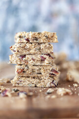 Stacked healthy oatmeal flapjacks, oatbars on rustic wooden chopping board
