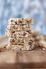 Stacked healthy oatmeal flapjacks, oatbars on rustic wooden chopping board