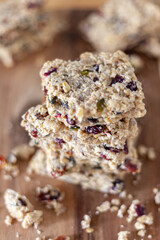 Stacked healthy oatmeal flapjacks, oatbars on rustic wooden chopping board