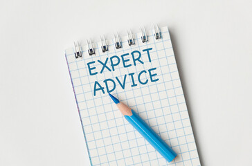 Top view of worker accessories on table with office tools and plant. Expert Advice words writing on paper