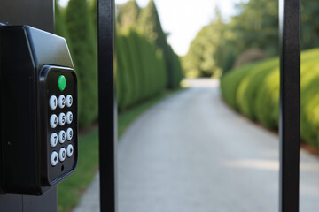 Keypad access control panel for opening automatic gate to private residential property. Electronic security system with digital code for secure entry, representing safety and exclusivity