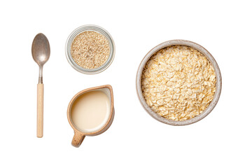 Spoon, bowl of oats, jug of milk, and jar of seeds arranged on a transparent background