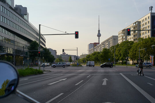 Urban intersection with traffic lights, city skyline, and TV tower in the background. Berlin, Germany