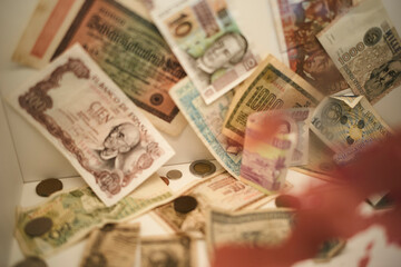 A collection of various international paper currencies and coins displayed together. Brussels, Belgium