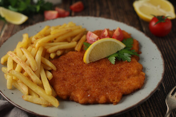 A Viennese schnizel with french fries	