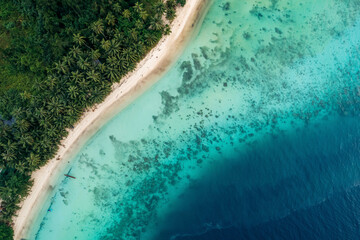 Aerial view of a tropical beach with turquoise waters and lush green foliage. Sipora village area, Mentawai, West Sumatra, Indonesia