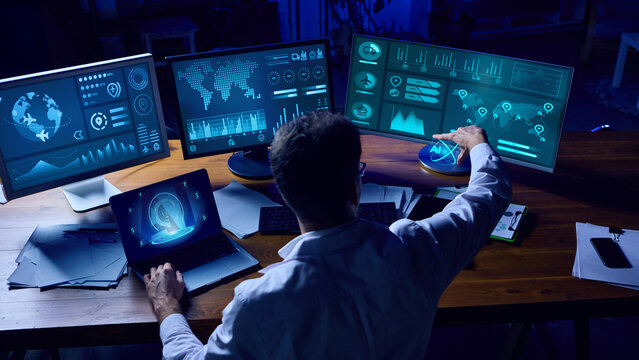 Analyst interacting with holographic AI system while managing big data on multiple screens. Concept of business technology, advanced analytics, cyber intelligence, and futuristic branding. Collage