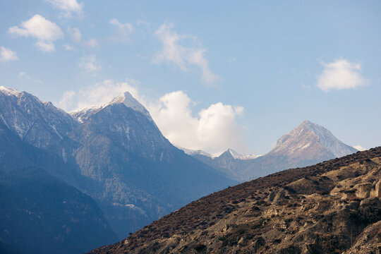 Majestic mountain range under a blue sky with a few scattered clouds. Marpha, Annapurna, Mustang District of the Gandaki Province, Nepal
