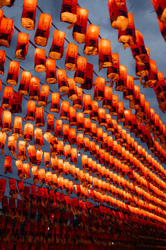 Rows of glowing red lanterns create a mesmerizing canopy against a dark sky. Xi'an, China