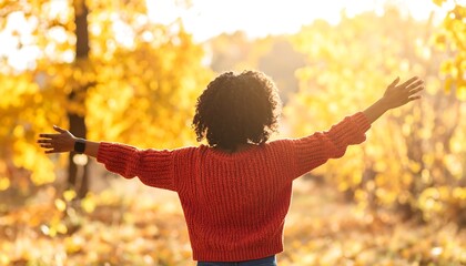 Child with arms outstretched in autumnal forest