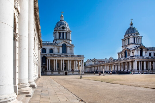Majestic Old Royal Naval College with domed buildings under a clear blue sky. London, United Kingdom