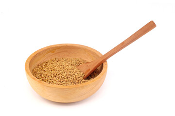 Fenugreek seeds in wooden bowl on white background