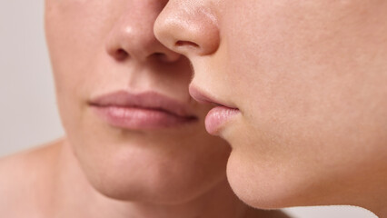 Obraz premium Artistic close up of lips and faces of young couple symbolizing intimacy and skincare aesthetics. Concept of editorial portraits, wellness lifestyle, cosmetic branding, and minimal beauty campaigns.