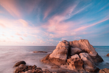 Rocky coastline along the seashore of Aruba with ocean, rocks and sunset