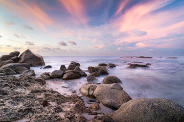 Rocky coastline along the seashore of Aruba with ocean, rocks and sunset