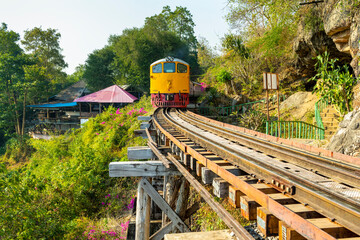 Train running across Thai-Burma Death Railway,at Tham Krasae Bridge,alongside the River Kwai,Kanchanaburi,Thailand.