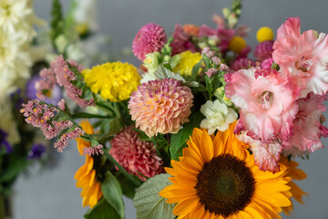 Diverse colorful flowers arrangement featuring sunflowers and dahlias