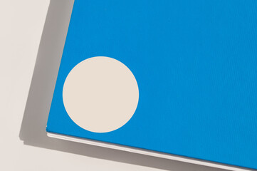 Blue book cover with white circle design on minimal background