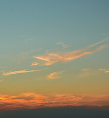 Magical sunset light glows behind clouds in dreamy sky scenev