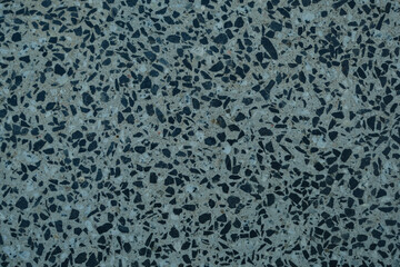 A close up of a black and white tile floor with a lot of small black