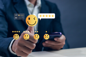 Close-up of businessman giving five rating with smiley face icon on smartphone, concept of positive...