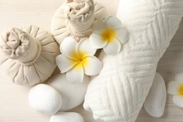 Beautiful spa composition with herbal bags on white wooden table, flat lay