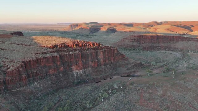 aerial drone shot of a remote bush camp along secluded George river in the beautiful red rolling hills of Millstream Chichester National Park, pilbara shire in West Australia.