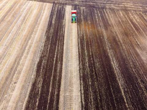 Aerial view of tractor plowing farmland in Norway