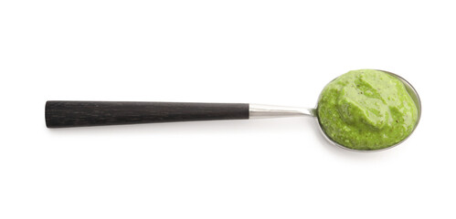 Fresh pesto sauce in spoon isolated on white, top view