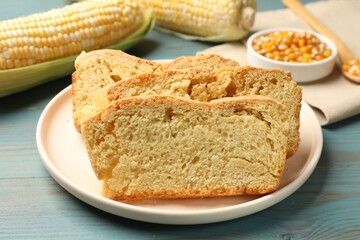 Freshly baked cornbread, cobs and seeds on light blue wooden table, closeup