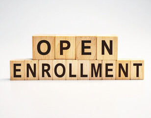 Open enrollment, text on wood blocks, healthcare concept, white backdrop. AI