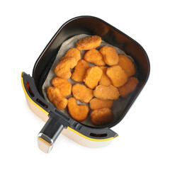 Air fryer basket with chicken nuggets isolated on white, top view