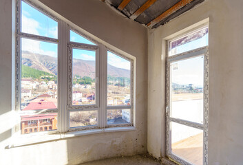 Fototapeta premium Room with window and view of water. Room in new building for fine finishing. Attic.