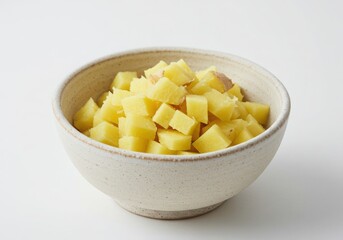 Bowl of diced potatoes isolated on white background