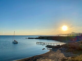 A beautiful view of a boat silhouette in the sea at sunset