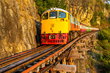 Train running across Thai-Burma Death Railway,at Tham Krasae Bridge,alongside the River Kwai,Kanchanaburi,Thailand.