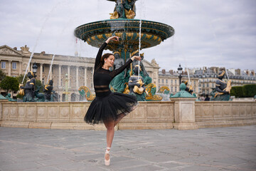 Graceful ballerina performing outdoors in black tutu