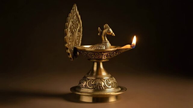 Ornate brass deepam featuring intricate designs displayed against a neutral background